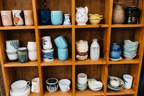 teacups and glasses on a shelf