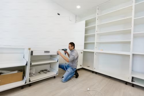 Man fixing a cabinet